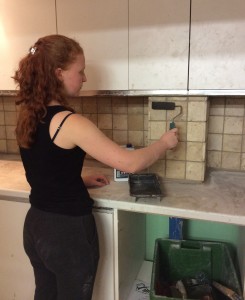 Here is Rebecca Tiling a kitchen area during her 3rd week.