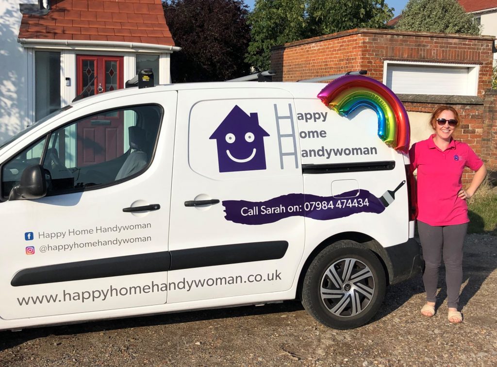 Photo of Sarah next to her Handywomand van