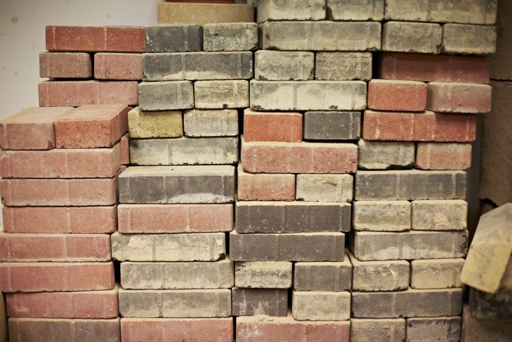 Featured image for 'What is the typical career path of a bricklayer?' article shows stacks of various bricks