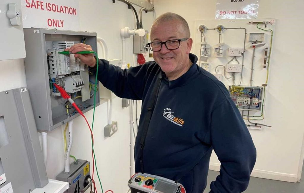 Image shows Robert Burgess, electrical tutor at Able Skills, in the electrical bays at the training centre.