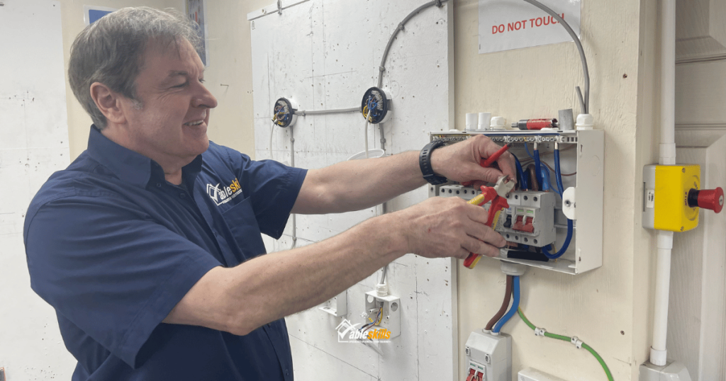 Able Skills Instructor demonstrating in the electrical workshop