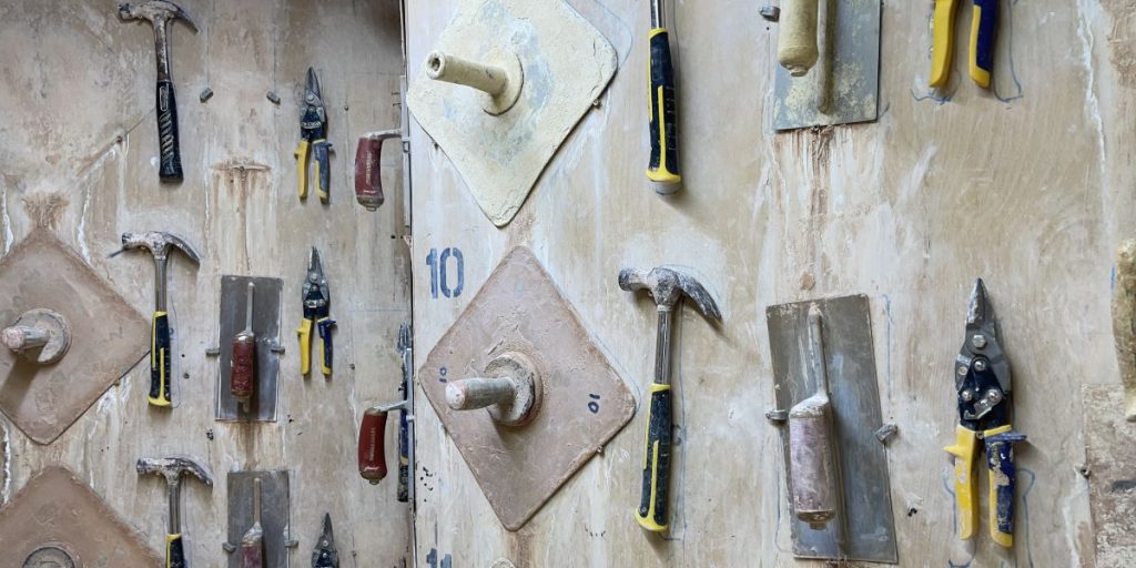 A selection of tools for plastering hanging on the wall