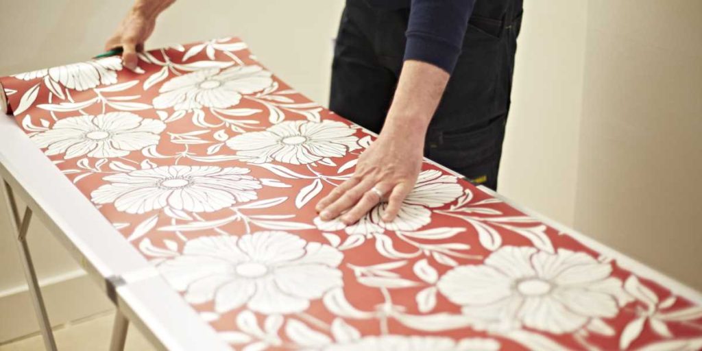 Floral wallpaper unrolled on a table