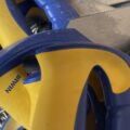 A pile of blue and yellow saws and some screws