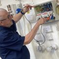 An Able Skills instructor is demonstrating electrical installation